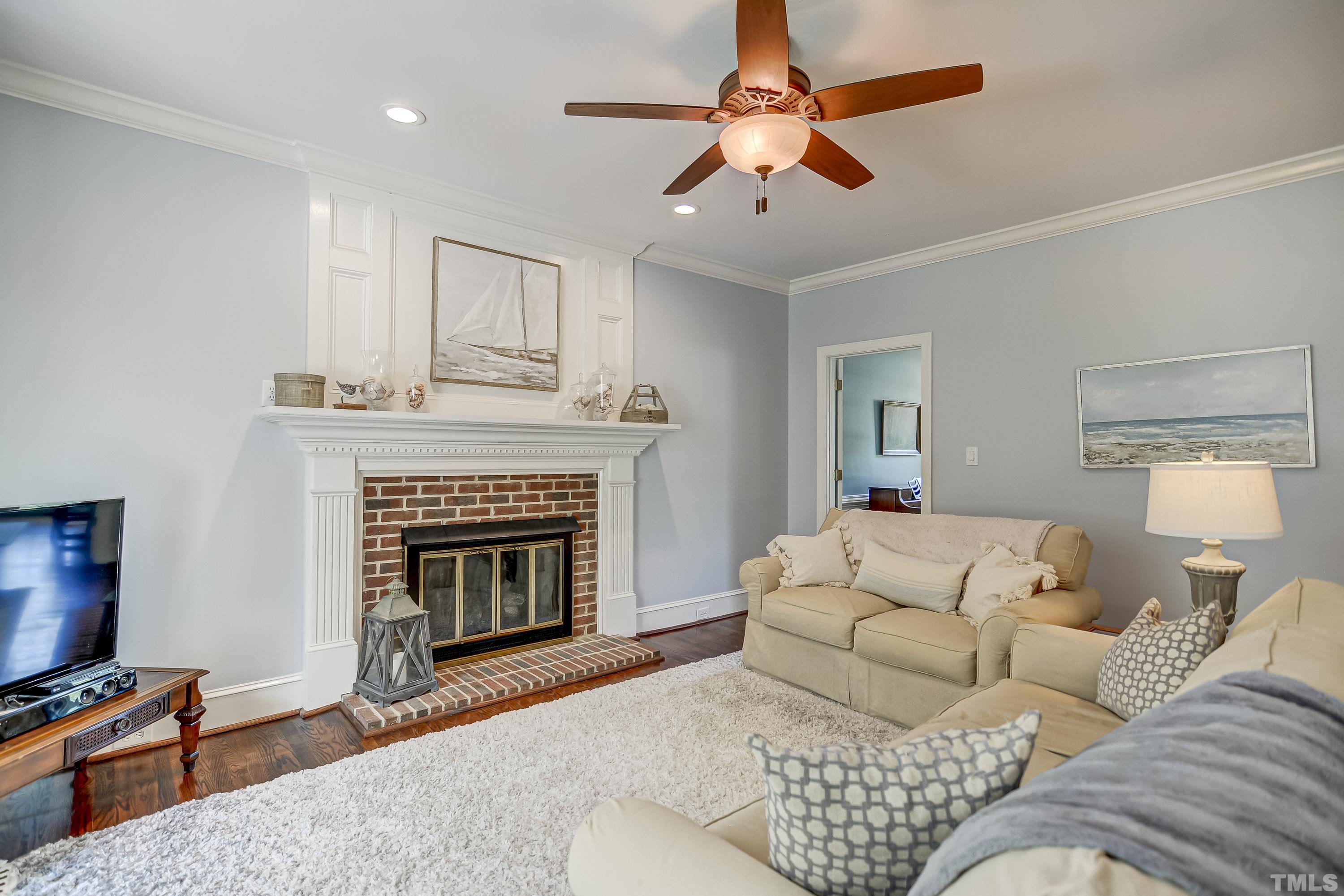 1309 Wescott Drive Raleigh, NC 27614 - Photo 5 of 32 a living room with furniture a fireplace and a flat screen tv