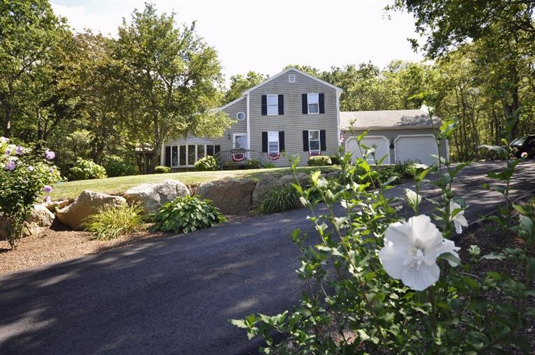 5 Easting Road Bourne, MA 02532 - Photo 1 of 26 a front view of a house with a yard and a garden