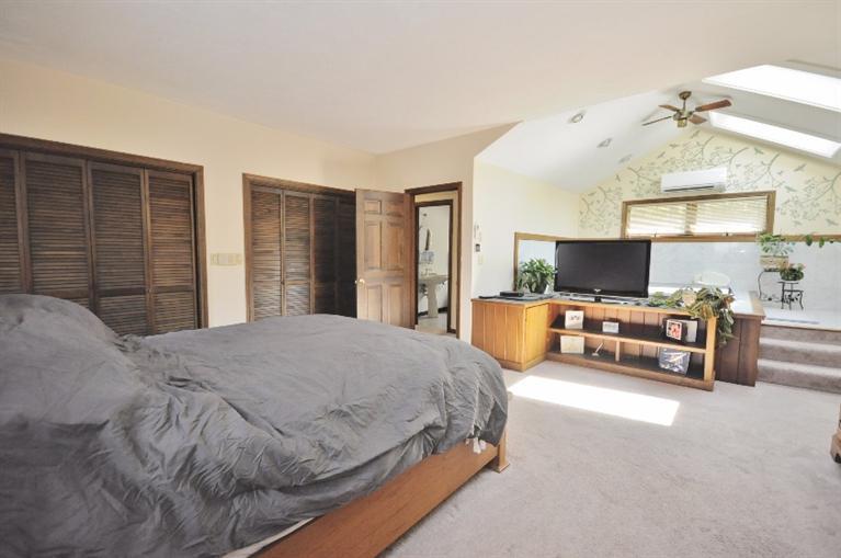 5 Easting Road Bourne, MA 02532 - Photo 19 of 26 a spacious bedroom with a bed and walk in closet