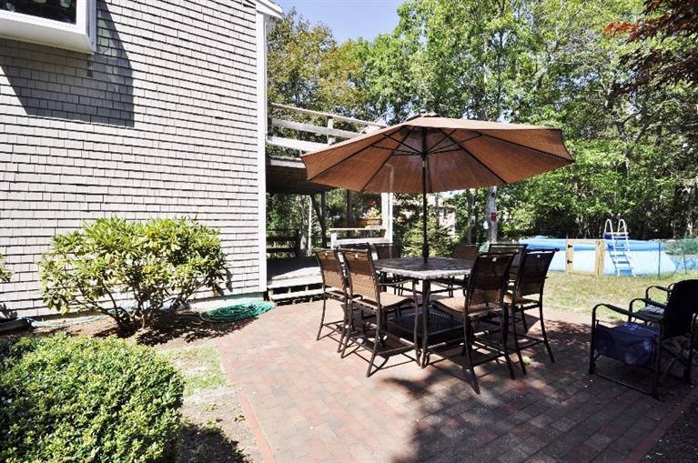 5 Easting Road Bourne, MA 02532 - Photo 21 of 26 a view of a patio with table and chairs under an umbrella
