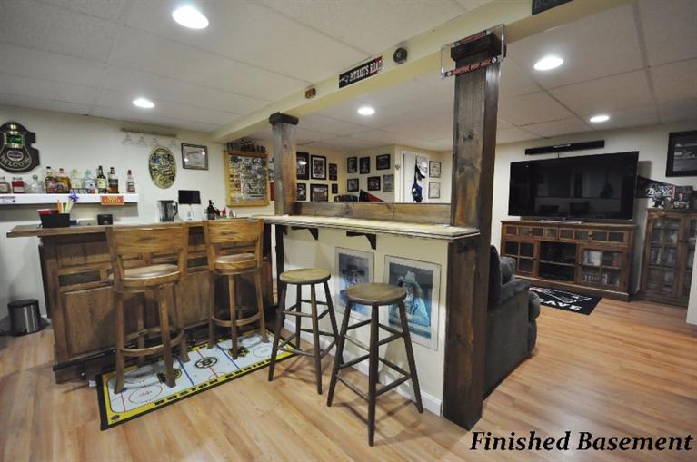 5 Easting Road Bourne, MA 02532 - Photo 22 of 26 a kitchen with stainless steel appliances kitchen island granite countertop a stove top oven a sink a dining table and chairs with wooden floor