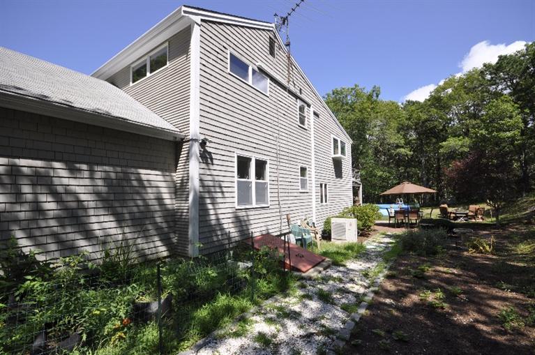 5 Easting Road Bourne, MA 02532 - Photo 26 of 26 a backyard of a house with table and chairs and a fire pit