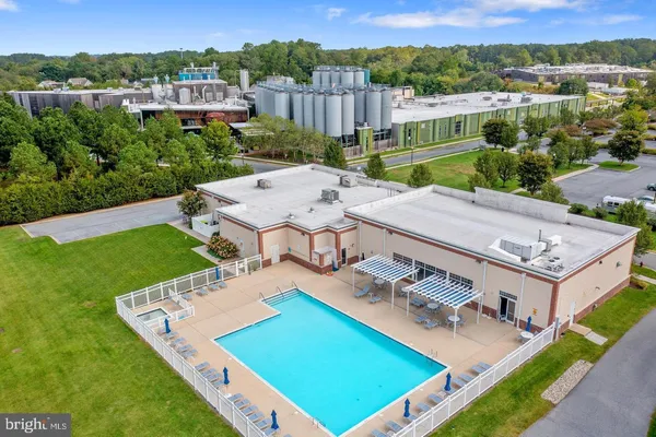 an aerial view of a house with pool garden and patio