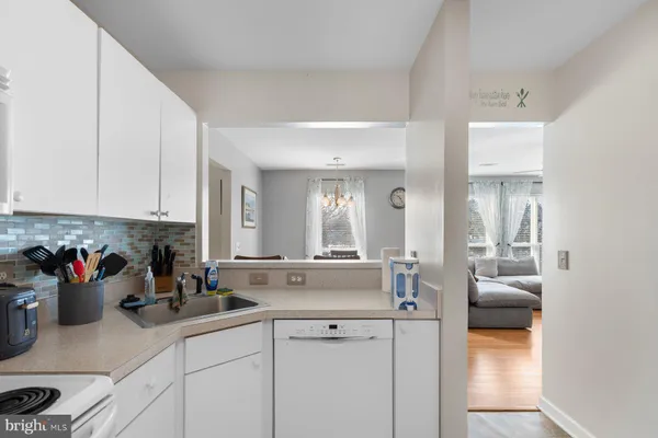a kitchen with stainless steel appliances white cabinets and a granite counter tops