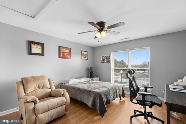 a bedroom with a bed couch and a window