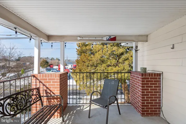 a view of a chairs and table in a balcony