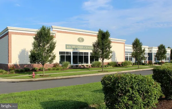 a view of a big building with a big yard and plants