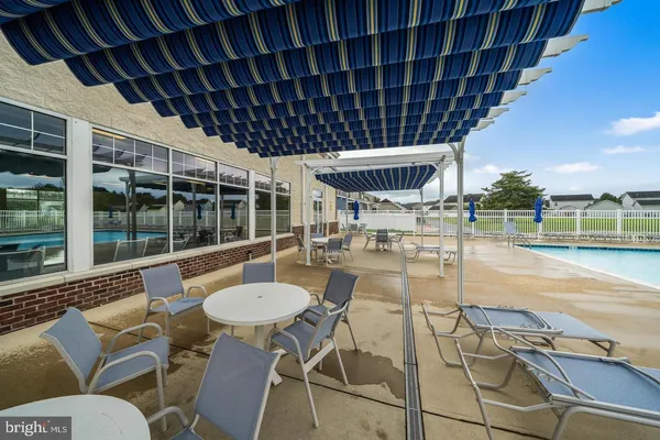 a view of a patio with swimming pool table and chairs