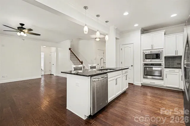 a view of kitchen with furniture and wooden floor
