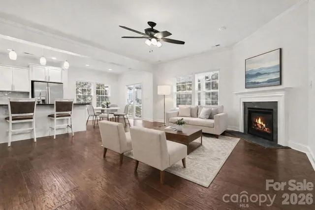 a view of empty room with wooden floor and a fireplace