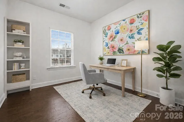 a bathroom with a granite countertop toilet sink and mirror