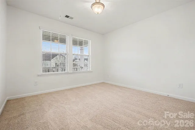 a living room with furniture a rug and a window