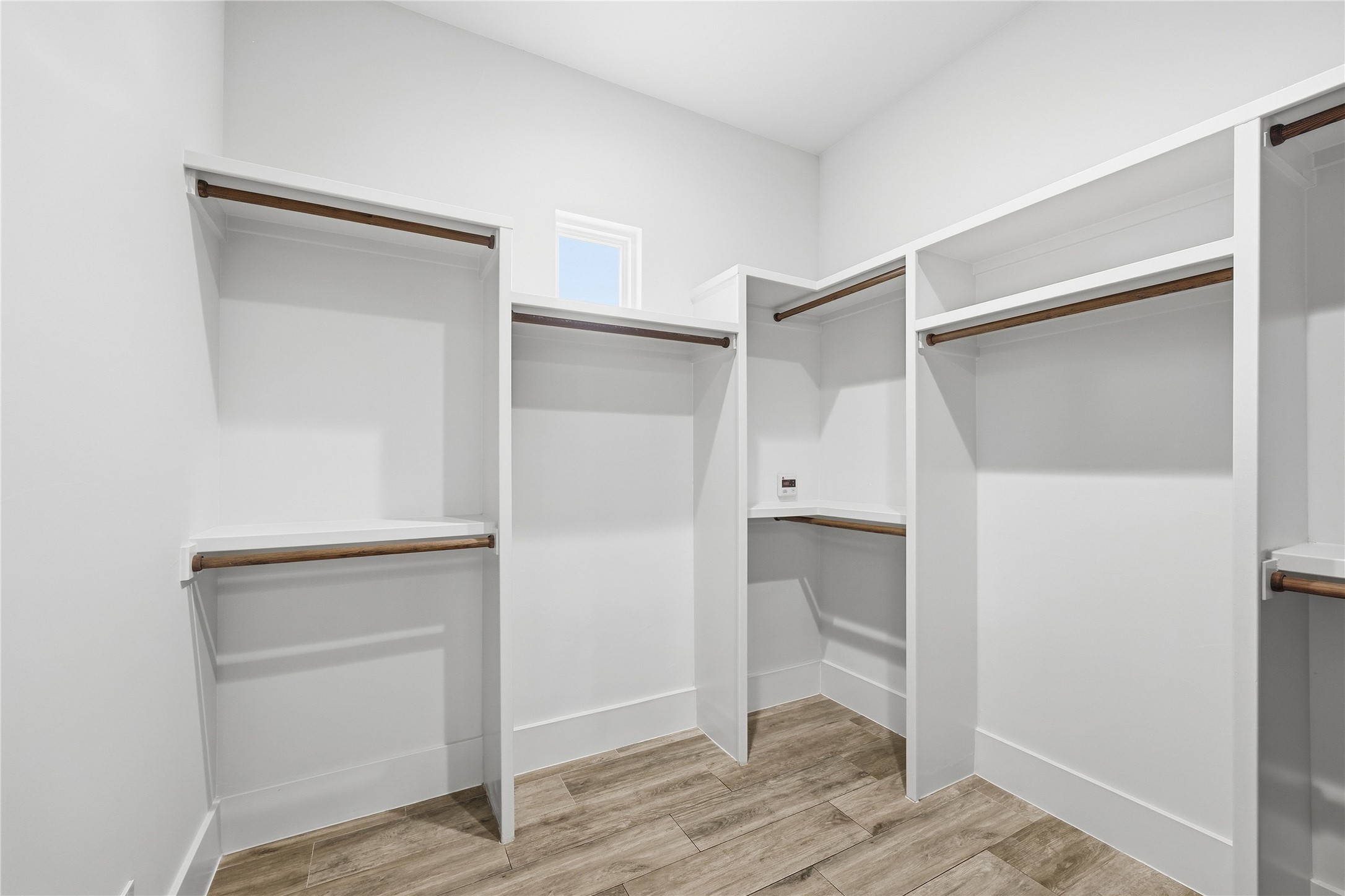 449 Ranch Falls Fair Oaks Ranch, TX 78015 - Photo 23 of 39 Generous closet organization system pairs with clean lines and durable wood-look flooring.