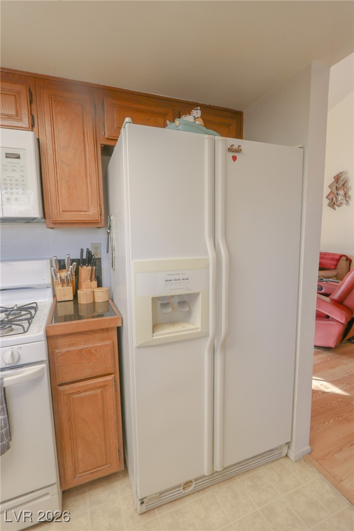 3201 La Mancha Way Henderson, NV 89014 - Photo 12 of 43 Kitchen with white appliances and brown cabinets