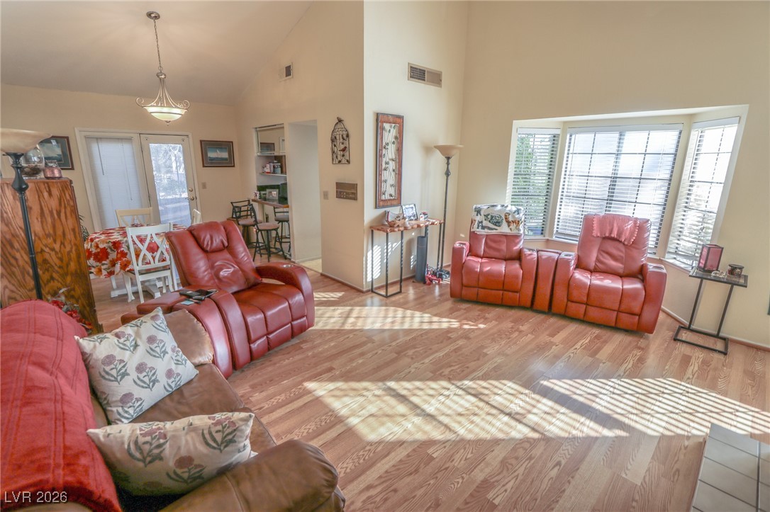 3201 La Mancha Way Henderson, NV 89014 - Photo 15 of 43 Living room with wood finished floors and high vaulted ceiling