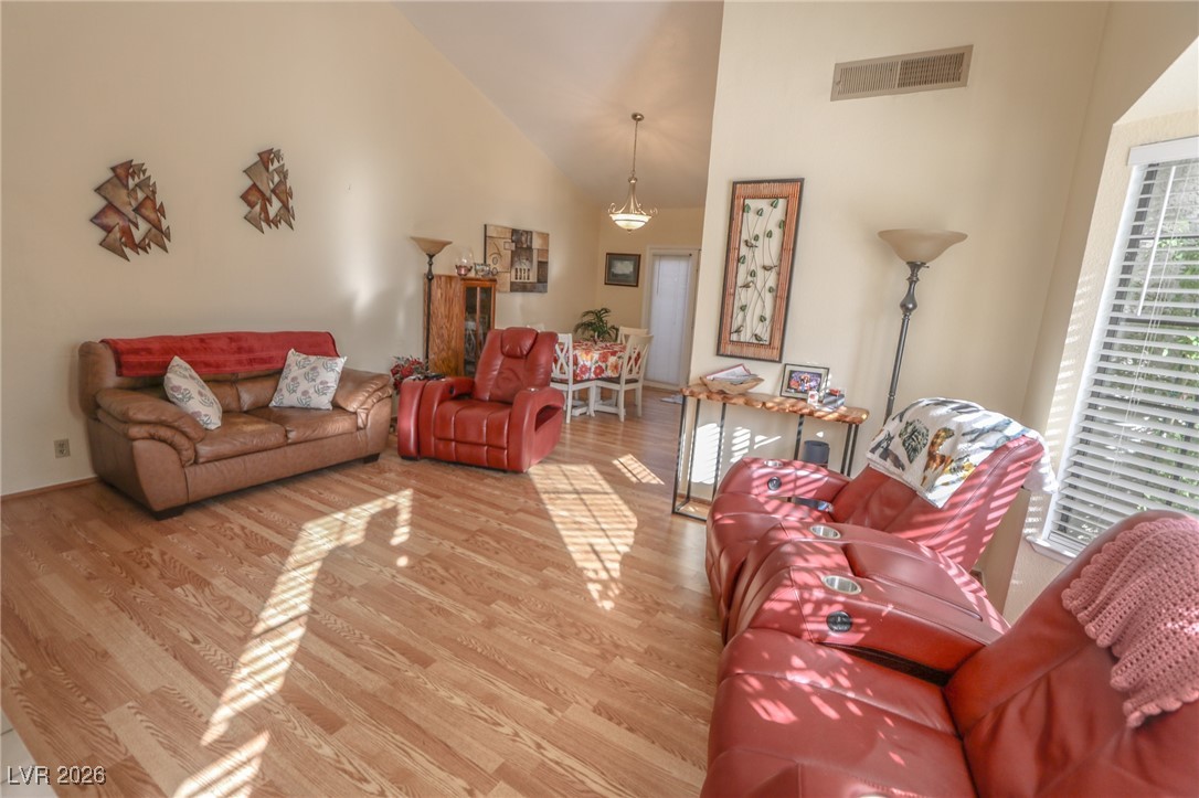 3201 La Mancha Way Henderson, NV 89014 - Photo 16 of 43 Living room featuring light wood-style floors and high vaulted ceiling