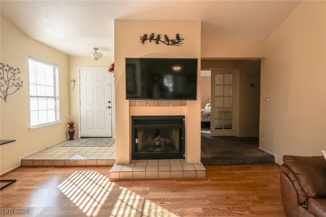 3201 La Mancha Way Henderson, NV 89014 - Photo 17 of 43 Living area featuring wood finished floors and a tile fireplace