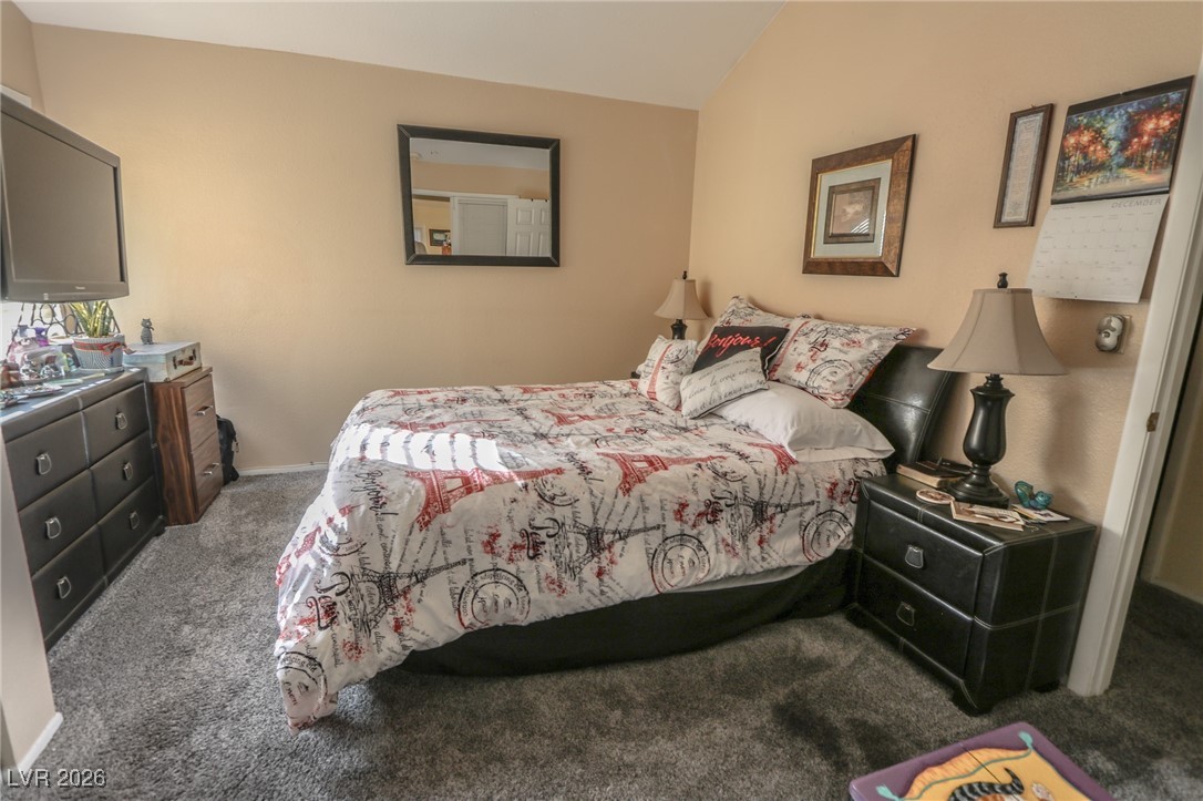 3201 La Mancha Way Henderson, NV 89014 - Photo 25 of 43 Carpeted bedroom with baseboards and vaulted ceiling