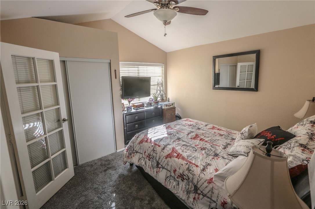 3201 La Mancha Way Henderson, NV 89014 - Photo 26 of 43 Bedroom featuring vaulted ceiling, carpet, ceiling fan, and a closet