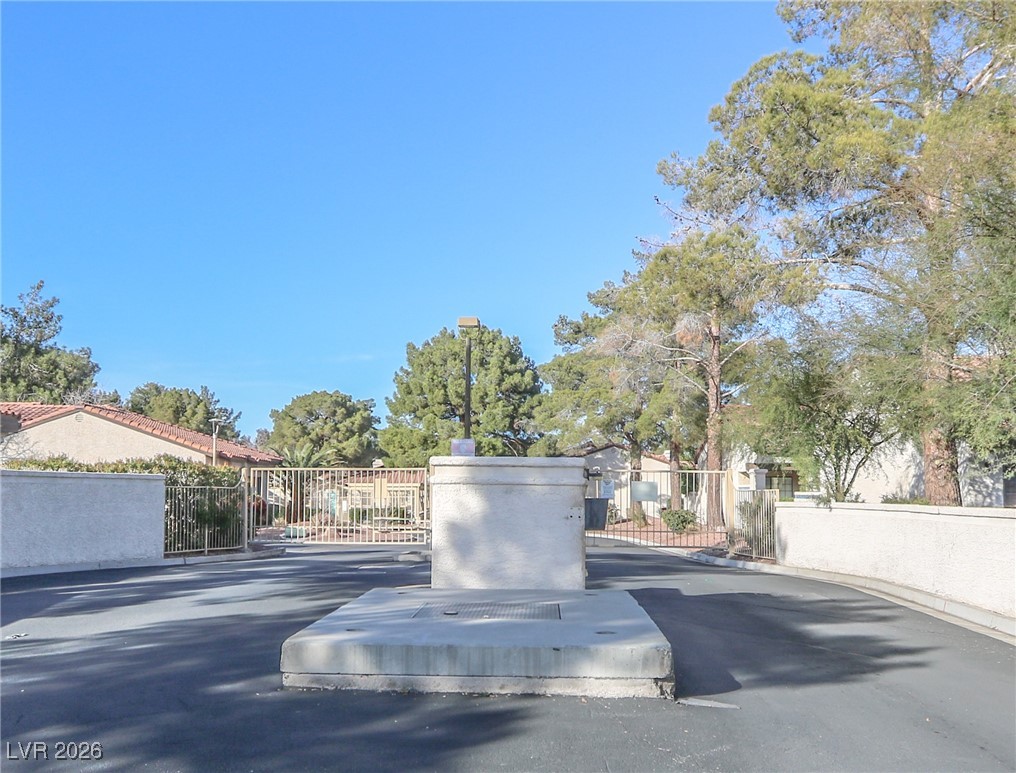 3201 La Mancha Way Henderson, NV 89014 - Photo 38 of 43 View of asphalt road featuring a gated entry, a gate, and curbs