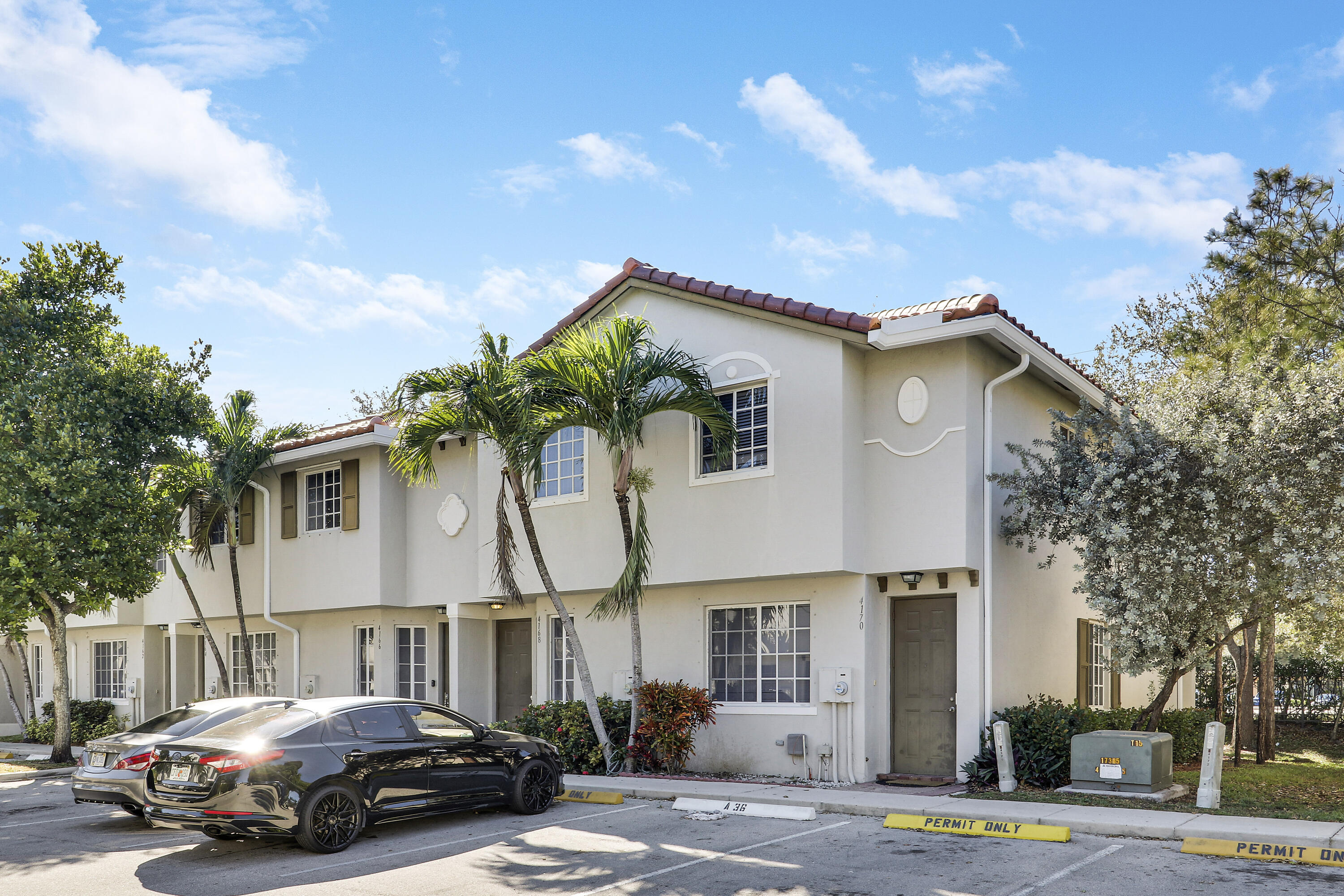 4170 Napoli Lake Drive Riviera Beach, FL 33410 - Photo 1 of 36 a car parked in front of a white house