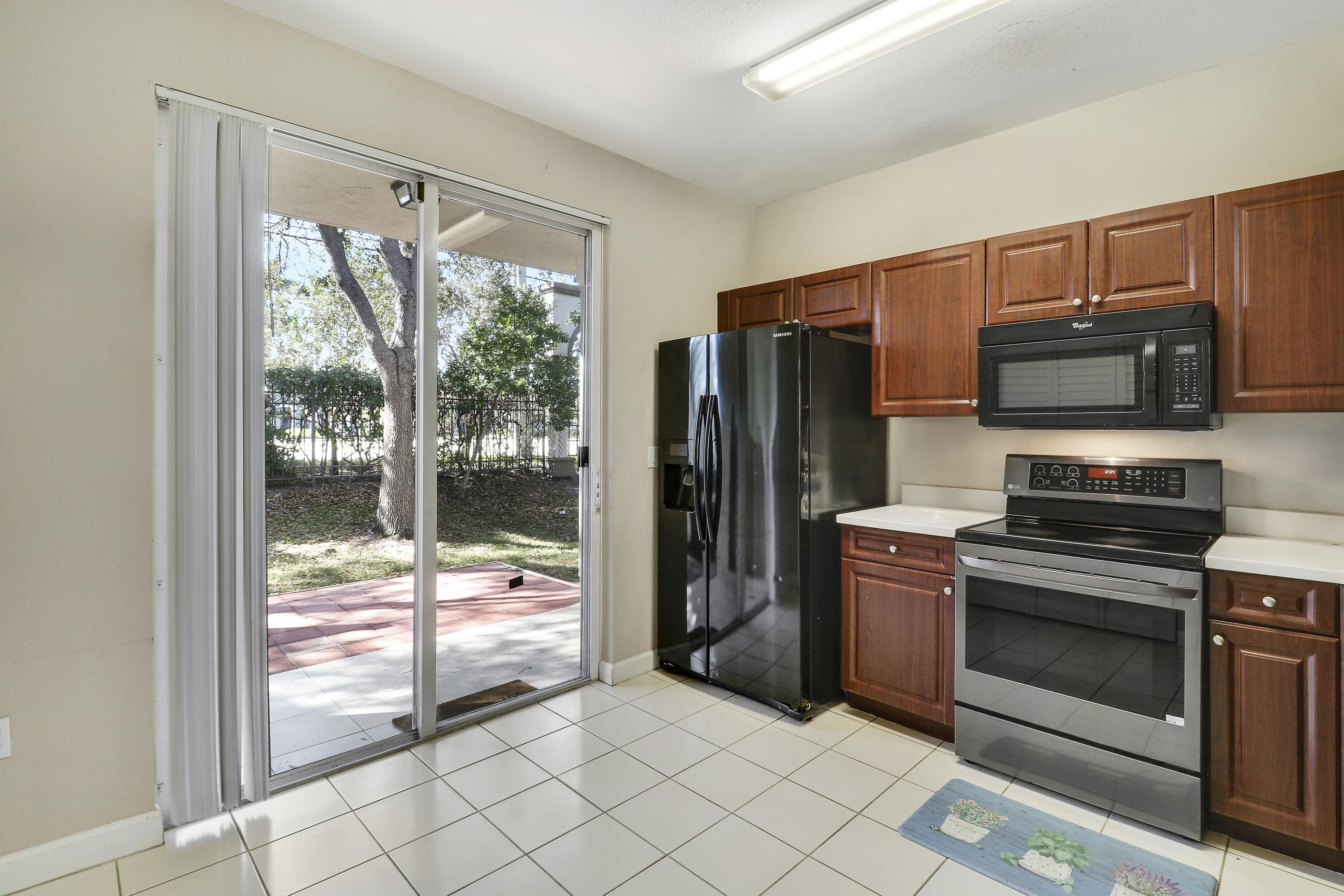 4170 Napoli Lake Drive Riviera Beach, FL 33410 - Photo 14 of 36 a kitchen with stainless steel appliances a stove and refrigerator