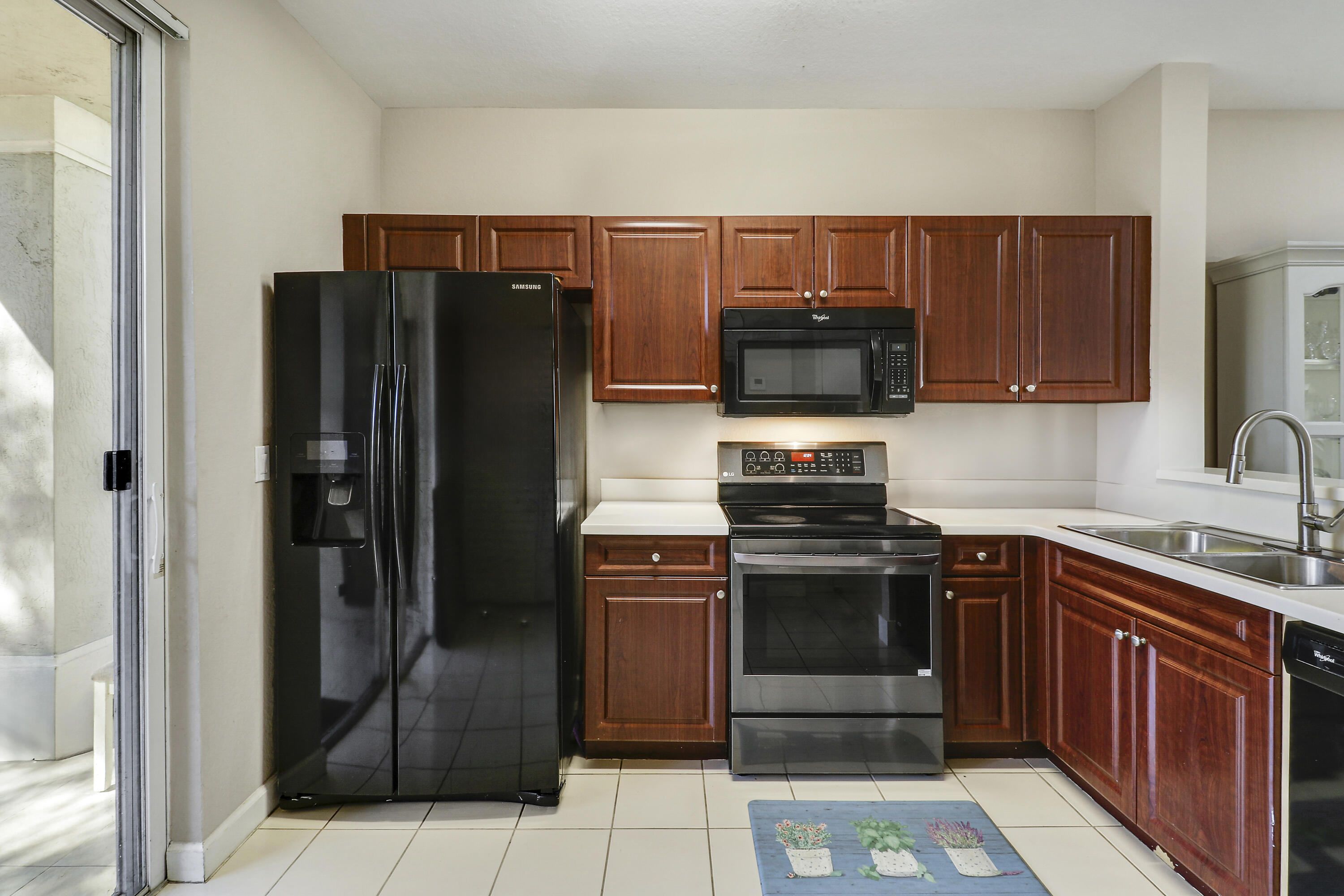 4170 Napoli Lake Drive Riviera Beach, FL 33410 - Photo 15 of 36 a kitchen with stainless steel appliances granite countertop a refrigerator and a stove top oven