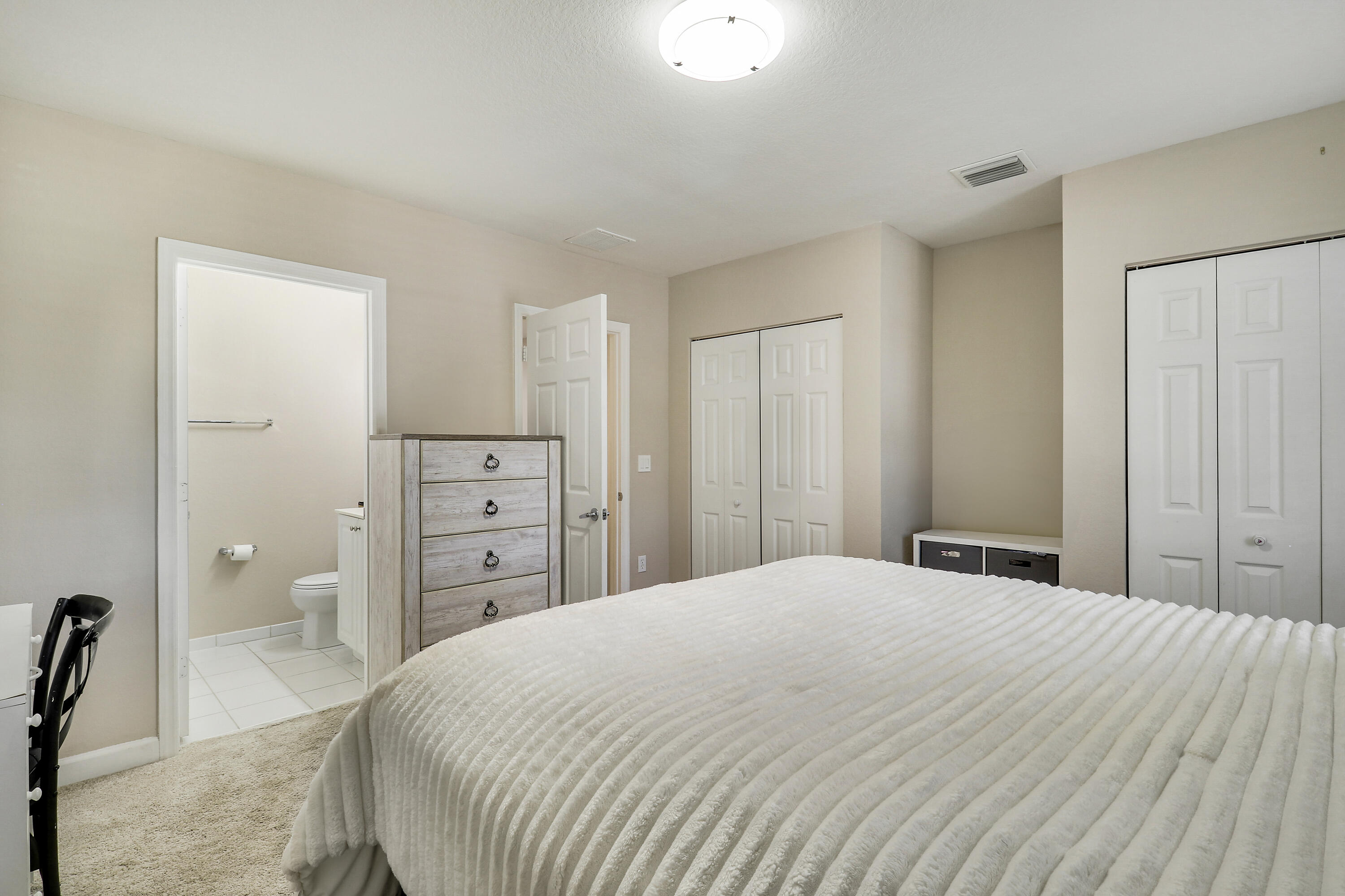 4170 Napoli Lake Drive Riviera Beach, FL 33410 - Photo 20 of 36 a bedroom with a large bed and a dresser