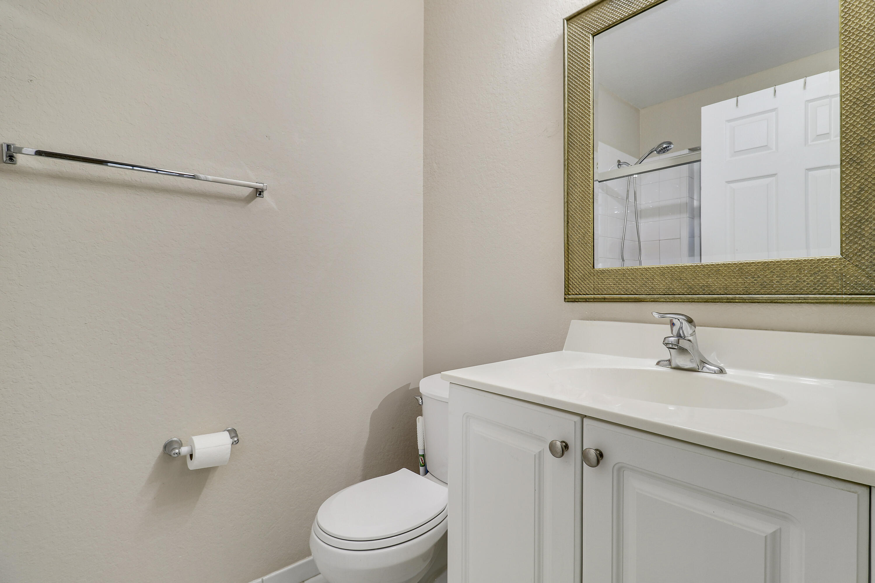 4170 Napoli Lake Drive Riviera Beach, FL 33410 - Photo 21 of 36 a bathroom with a sink a toilet and a mirror