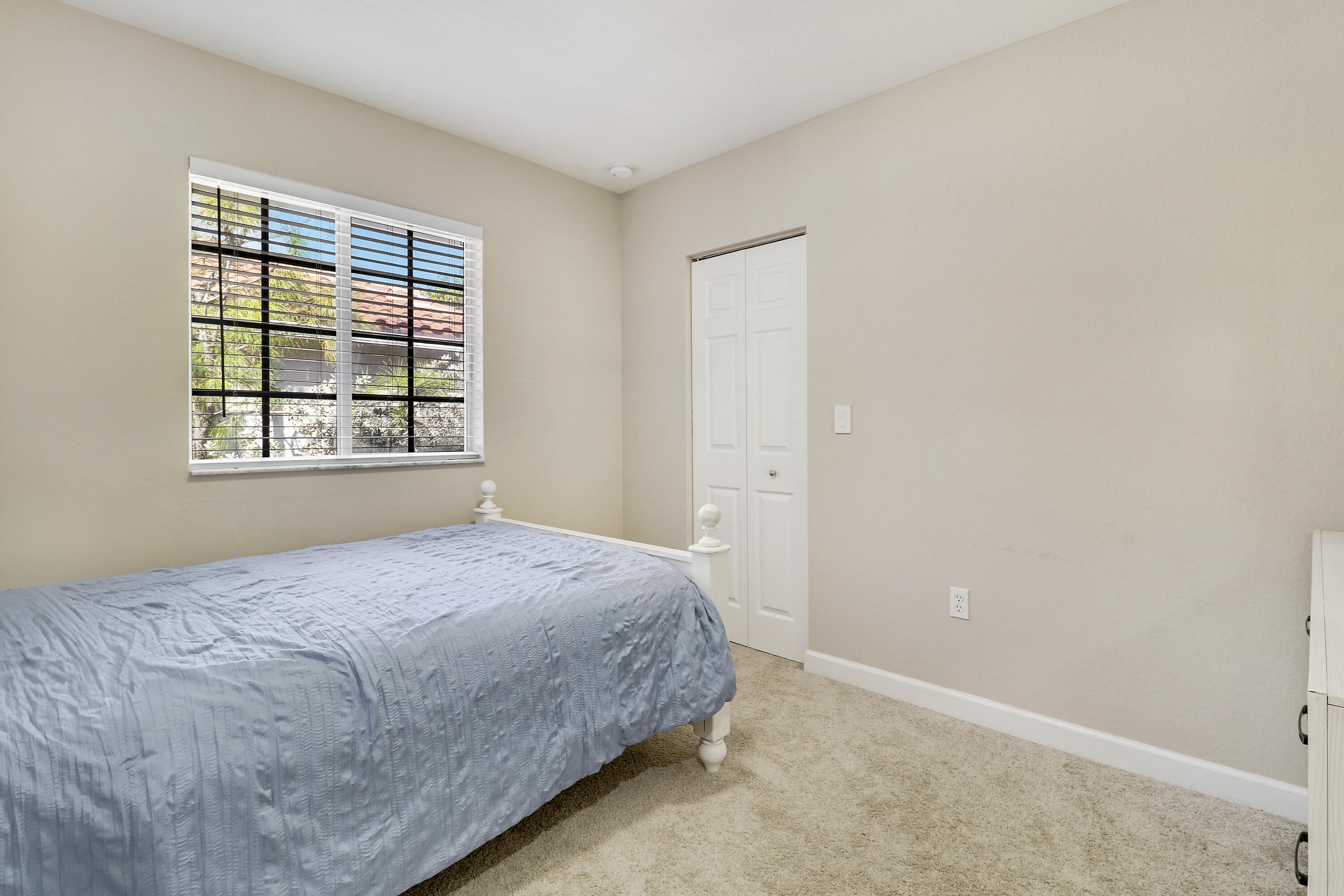 4170 Napoli Lake Drive Riviera Beach, FL 33410 - Photo 22 of 36 a bedroom with a bed and a window