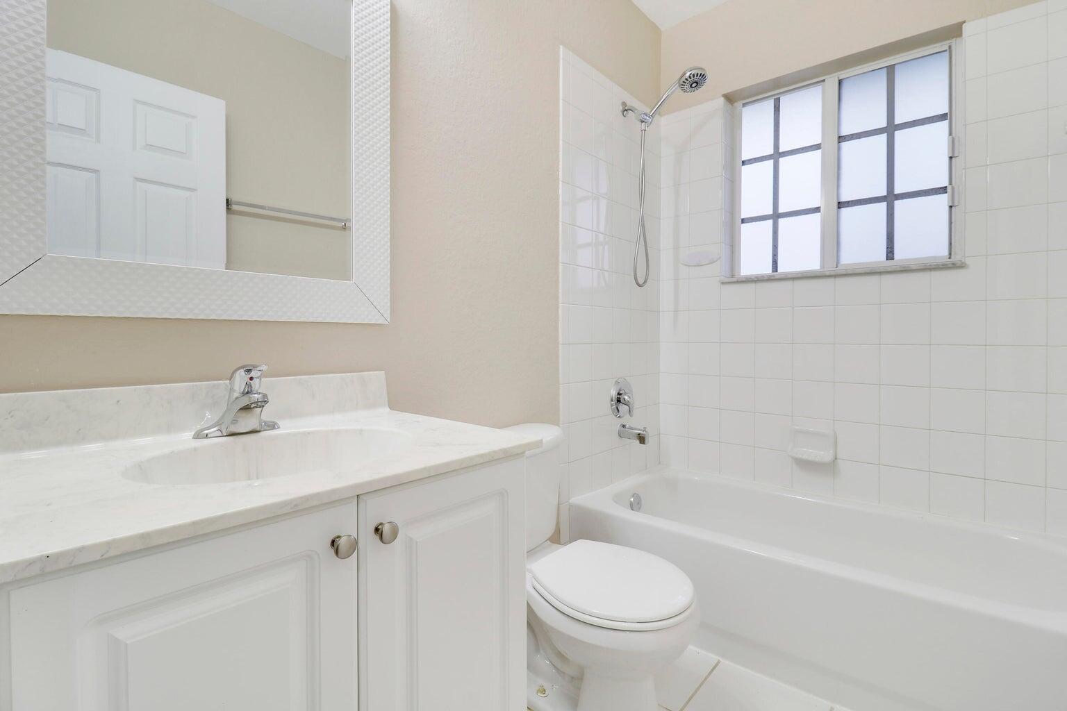 4170 Napoli Lake Drive Riviera Beach, FL 33410 - Photo 23 of 36 a bathroom with a sink a toilet and a bathtub