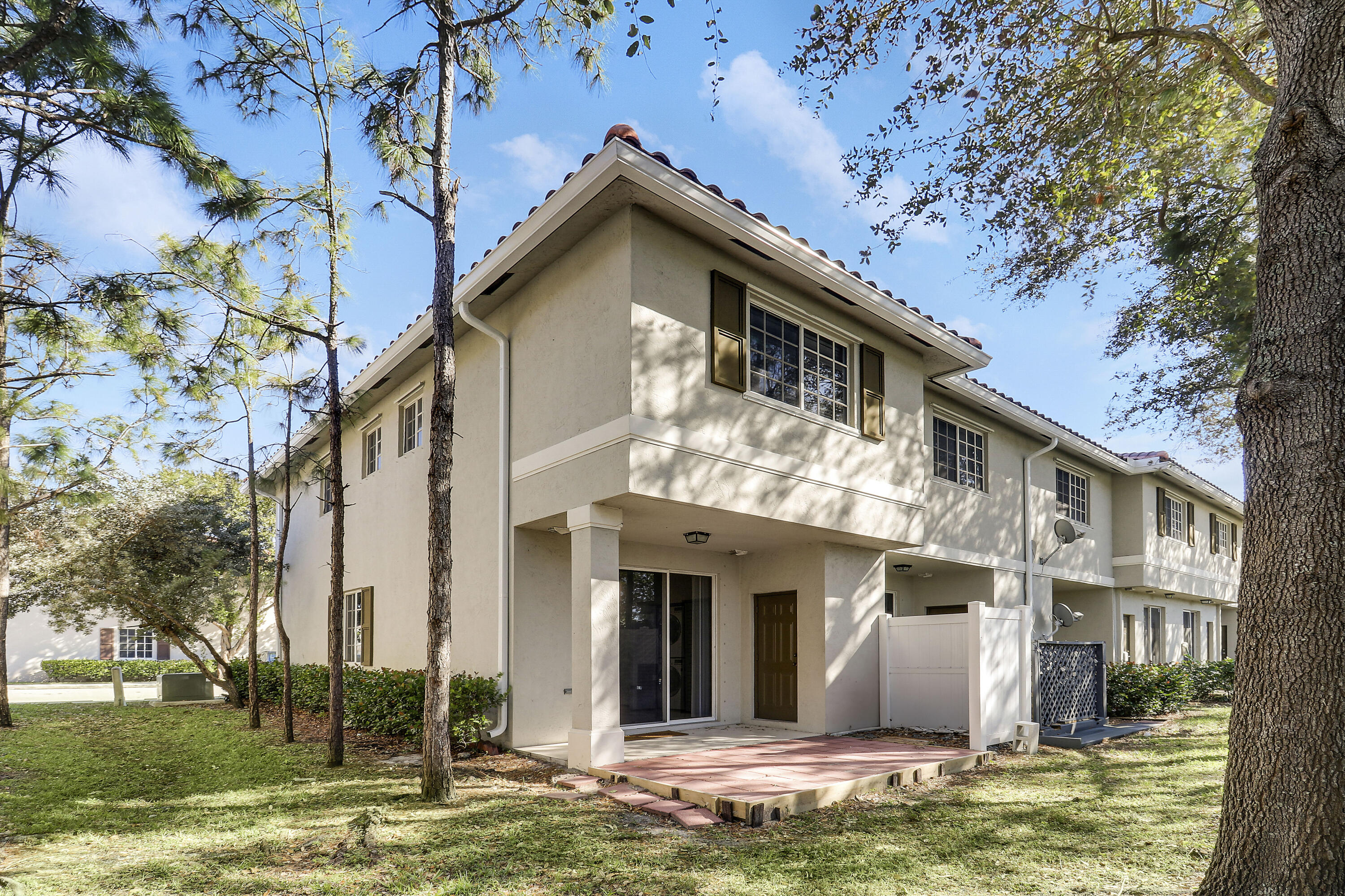 4170 Napoli Lake Drive Riviera Beach, FL 33410 - Photo 25 of 36 a view of a house with a yard