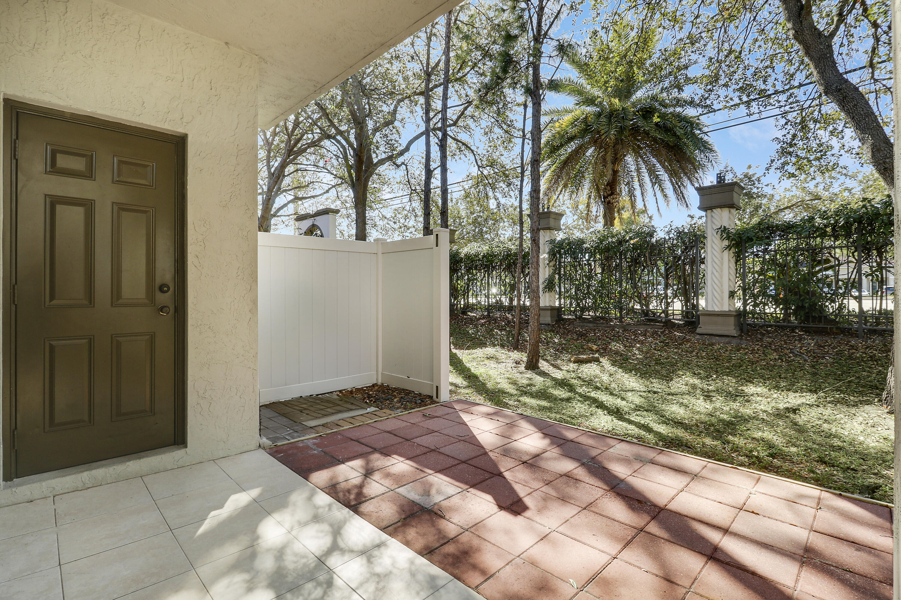 4170 Napoli Lake Drive Riviera Beach, FL 33410 - Photo 26 of 36 a backyard of a house with palm trees