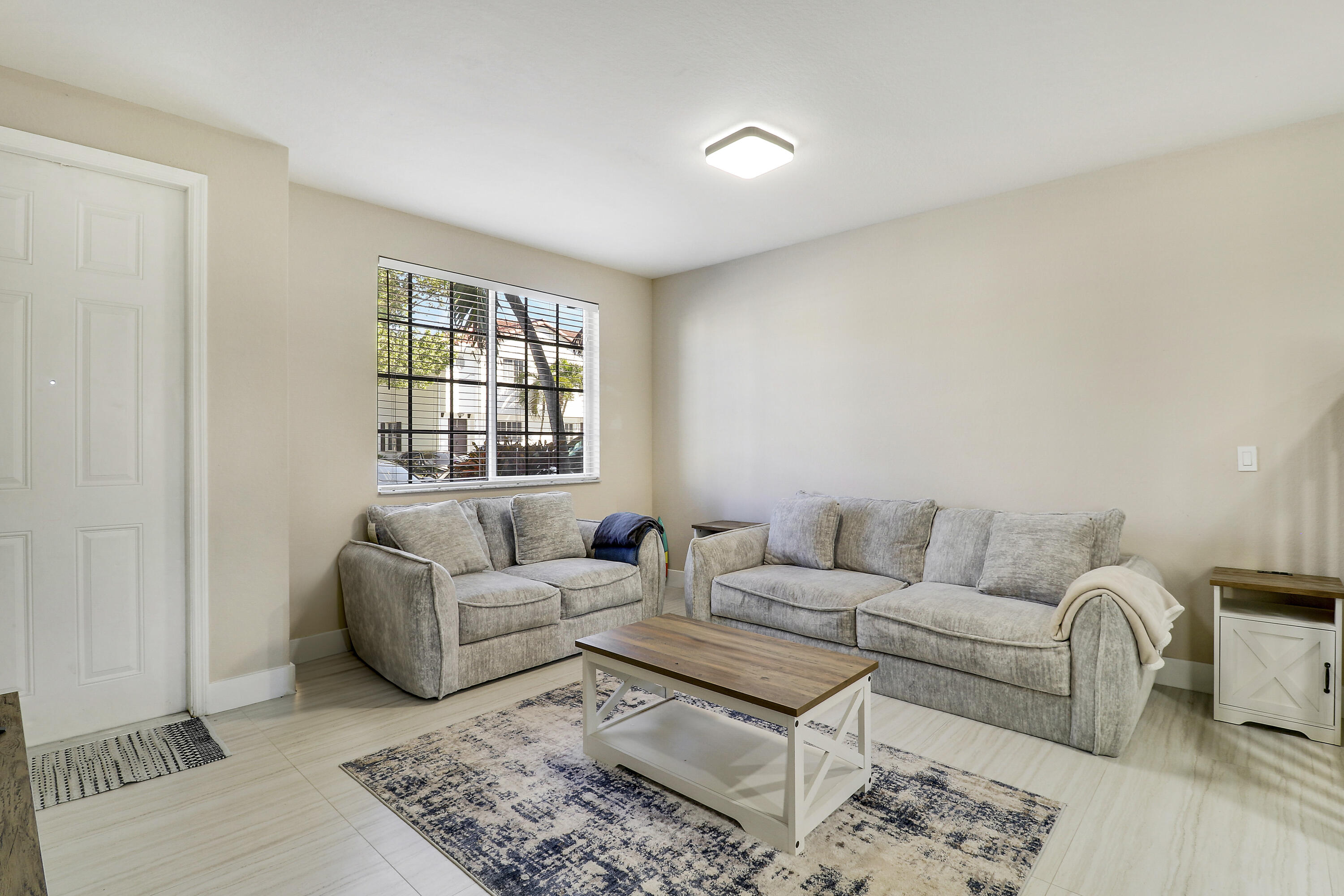 4170 Napoli Lake Drive Riviera Beach, FL 33410 - Photo 4 of 36 a living room with furniture and a window