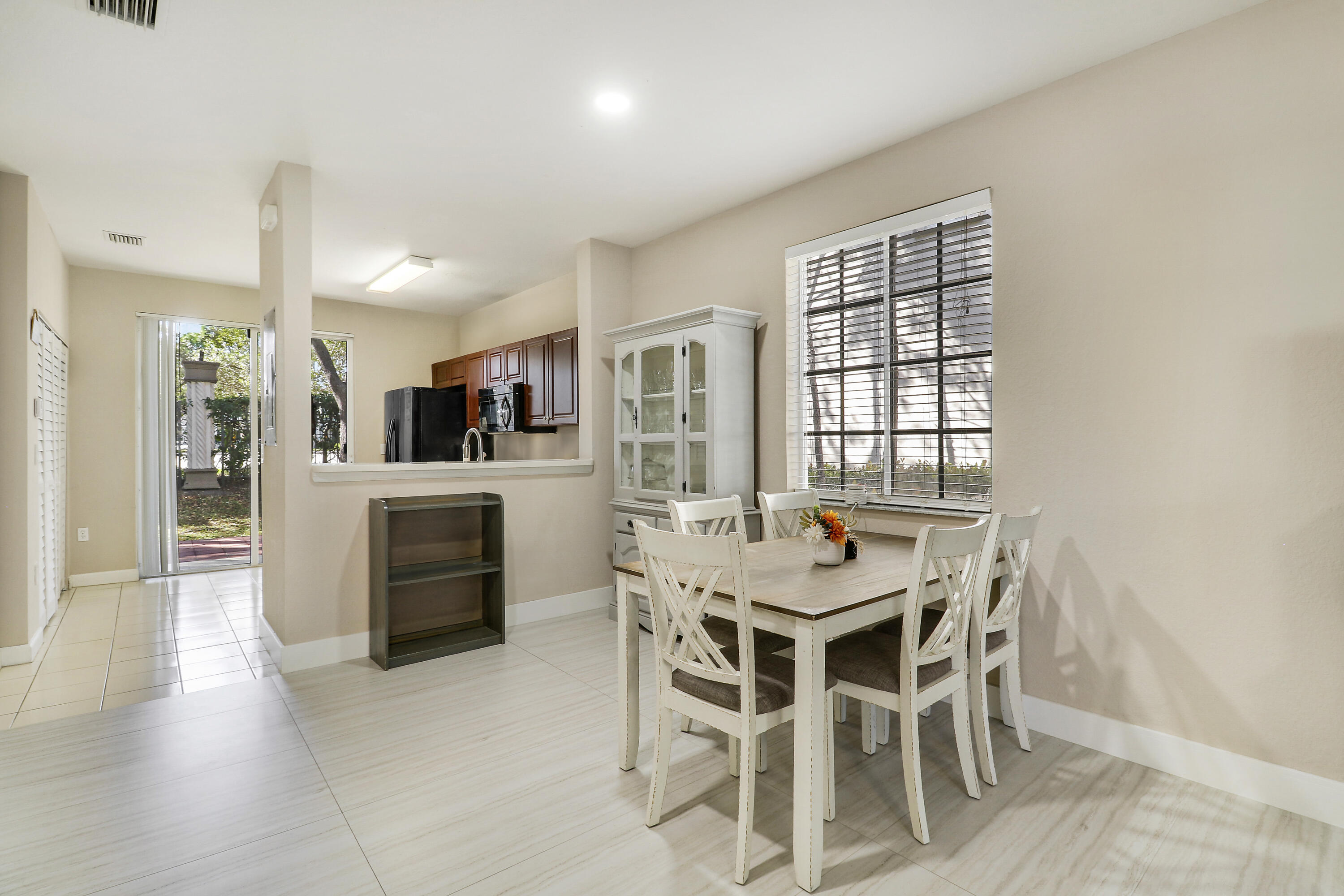 4170 Napoli Lake Drive Riviera Beach, FL 33410 - Photo 9 of 36 a view of a dining room with furniture and window