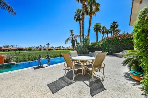 a view of a table and chairs in the garden
