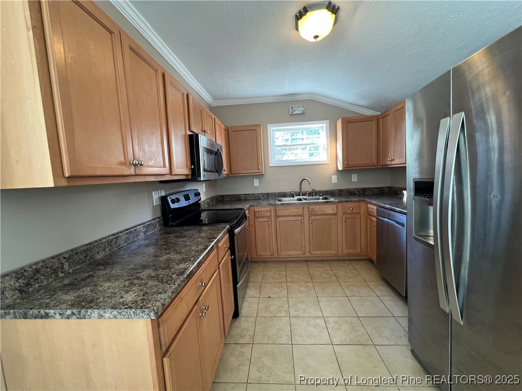 1443 Strickland Bridge Road Fayetteville, NC 28304 - Photo 5 of 10 a kitchen with stainless steel appliances granite countertop a sink stove and refrigerator