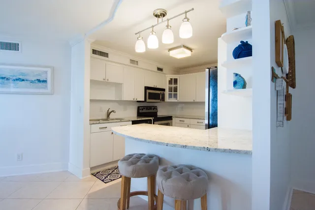 a kitchen with stainless steel appliances a sink and a refrigerator