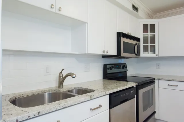a bathroom with a refrigerator and a sink