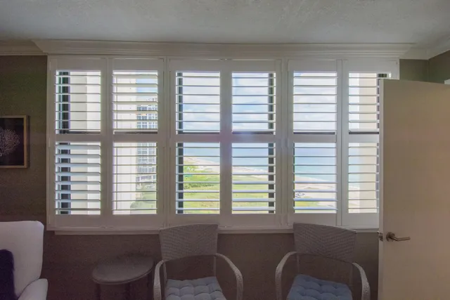a bathroom with a granite countertop sink a toilet and a mirror