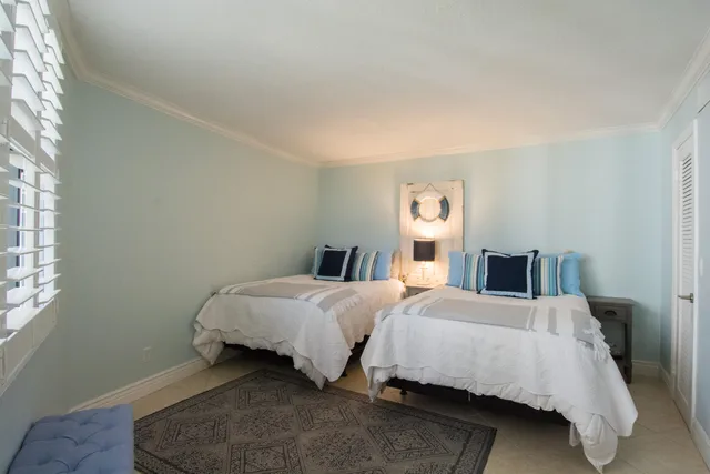 a bedroom with a bed and chair