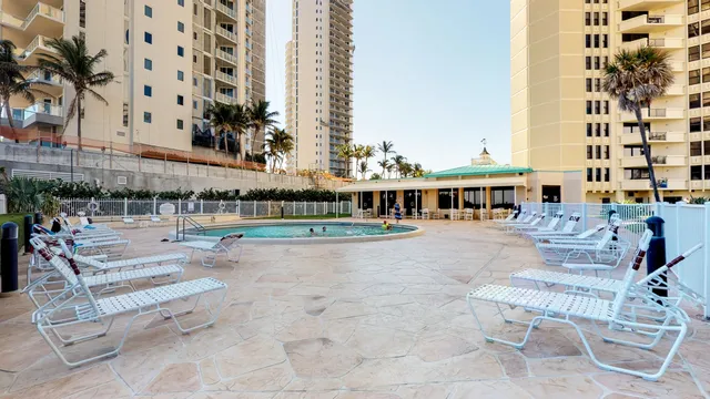 a front view of a house with garden and sitting area