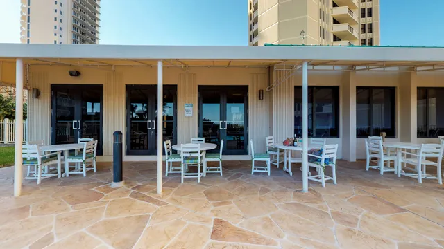 a front view of a house with garden and plants
