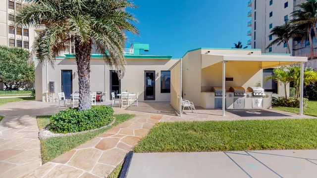 a kitchen with stainless steel appliances granite countertop a sink a stove and a refrigerator