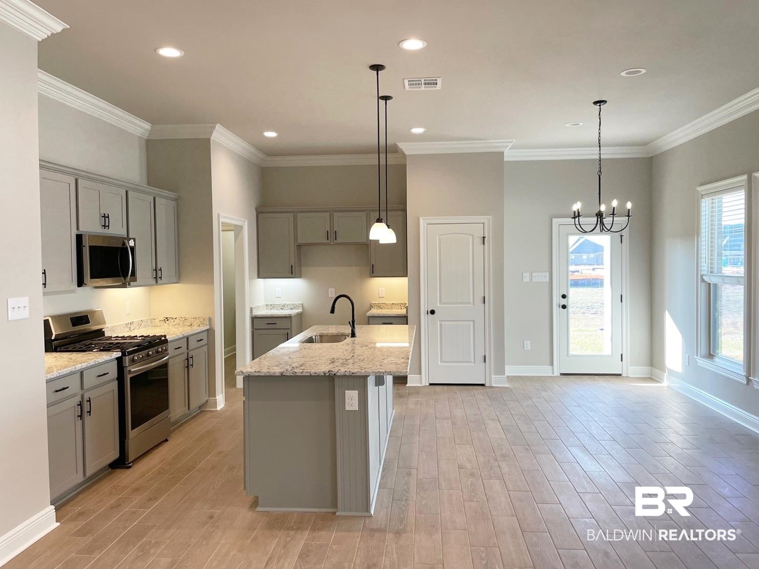 1355 Fenton Circle Foley, AL 36535 - Photo 2 of 17 Kitchen with crown molding, sink, an island with sink, and stainless steel appliances