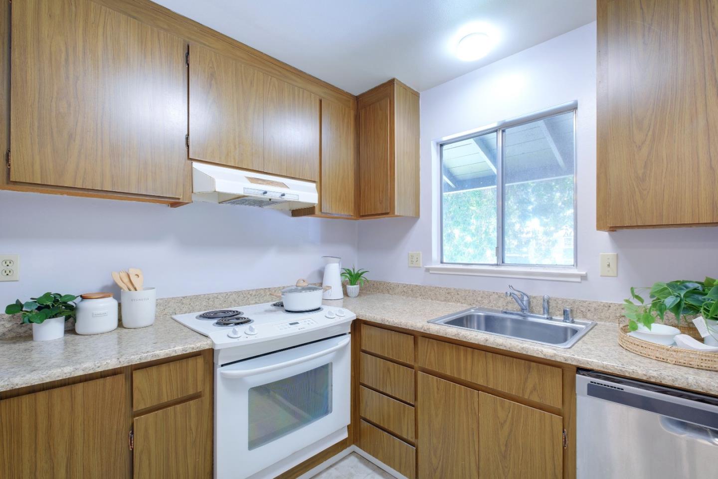 50 East Middlefield Road, Unit 40 Mountain View, CA 94043 - Photo 21 of 41 a kitchen with a sink a stove cabinets and wooden floor