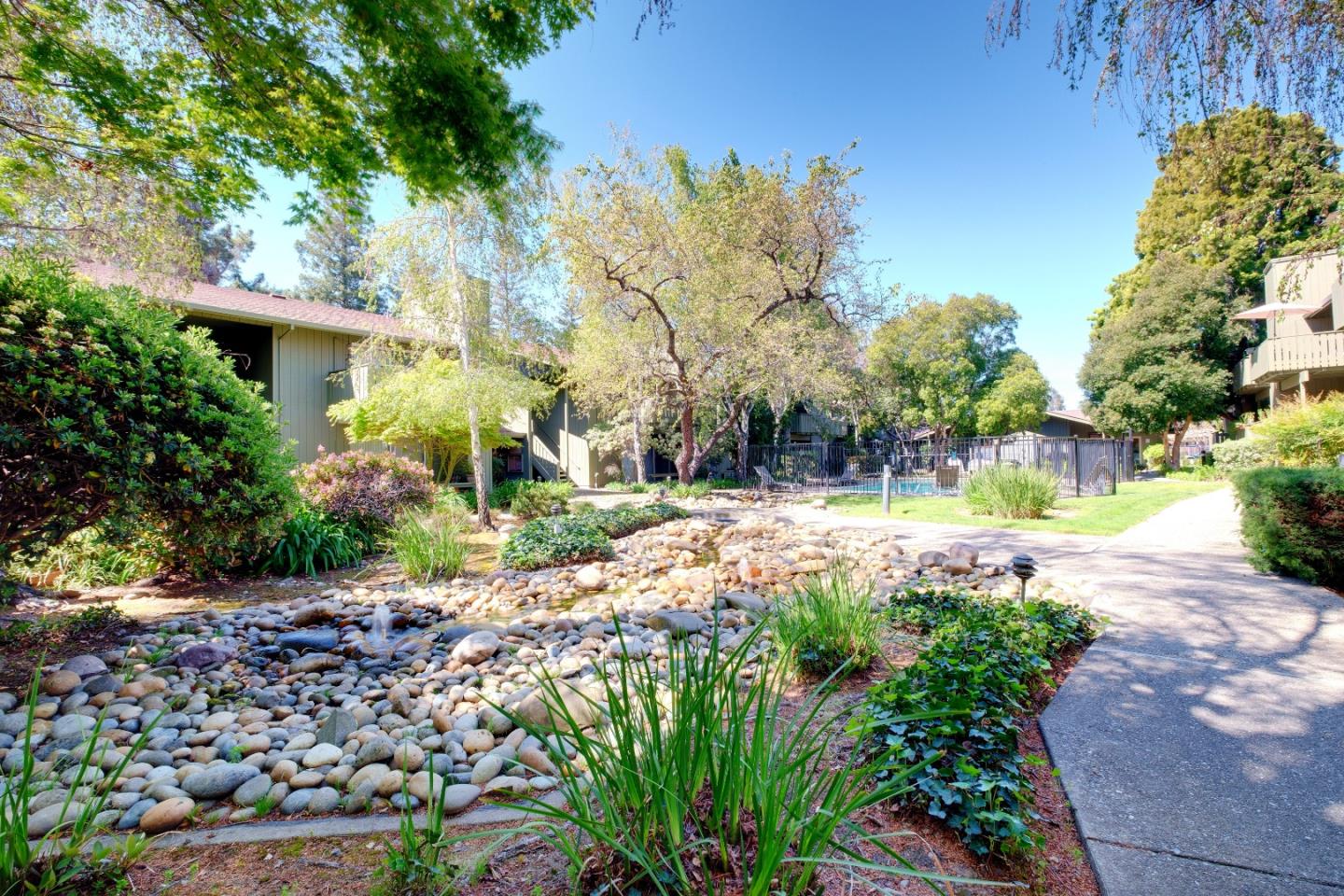 50 East Middlefield Road, Unit 40 Mountain View, CA 94043 - Photo 36 of 41 a view of a garden with a bench