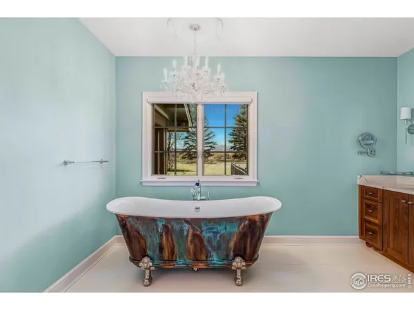 a spacious bathroom with a granite countertop sink a mirror and a bathtub