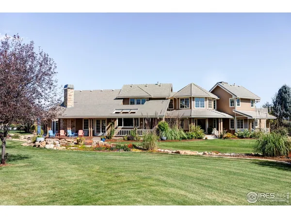 a front view of building with yard play and outdoor seating