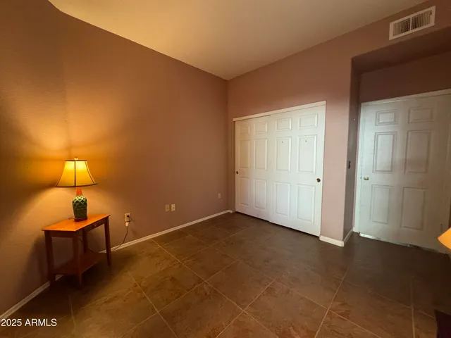 a room with a lamp and a window